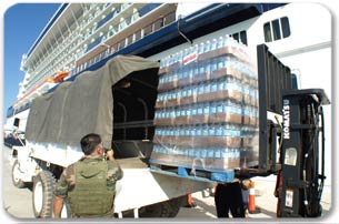 Palettes of water being loaded into a UN truck