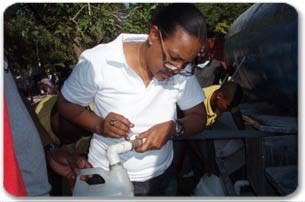 Maryse Kedar and her team distribute water to the Haitian people