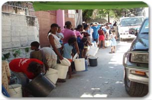 Haitians stand in line to collect water
