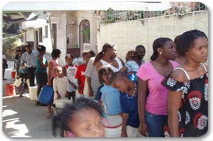 Haitians stand in line to collect water