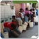 Haitians stand in line to collect water